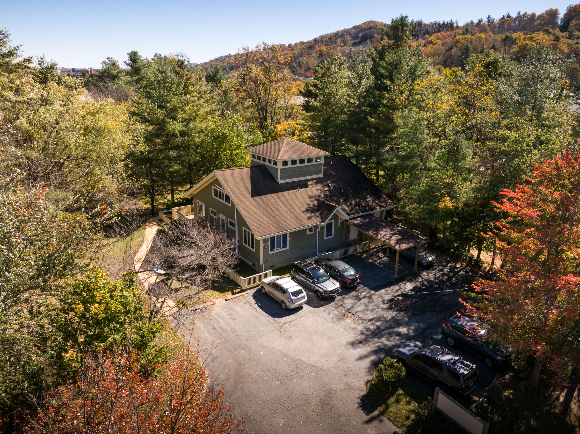 Aerial view of building with fall foliage