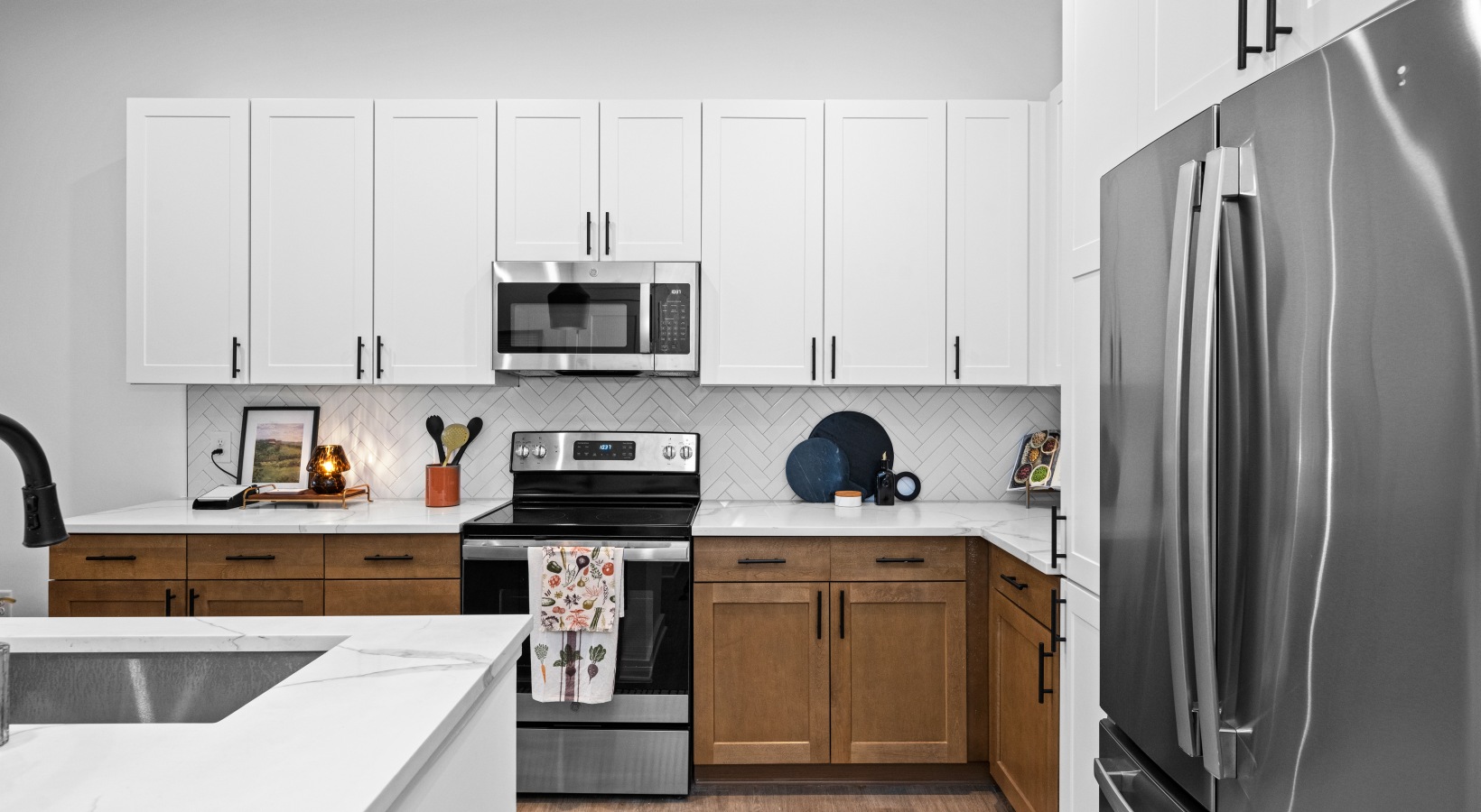 Modern kitchen with white cabinets and stainless steel appliances